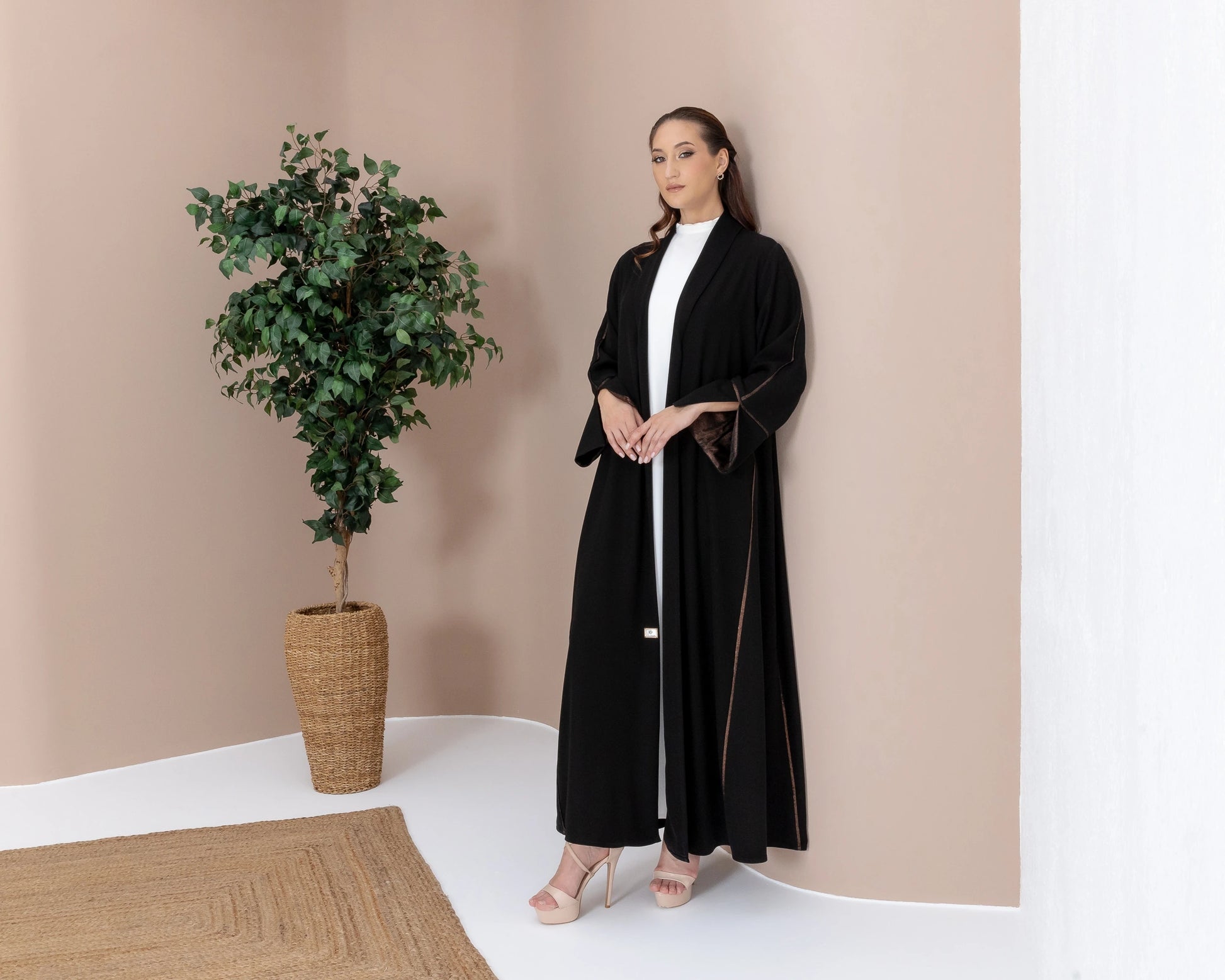 SAMRA Noir Bronze Editorial pose luxury abaya with bronze edge detailing