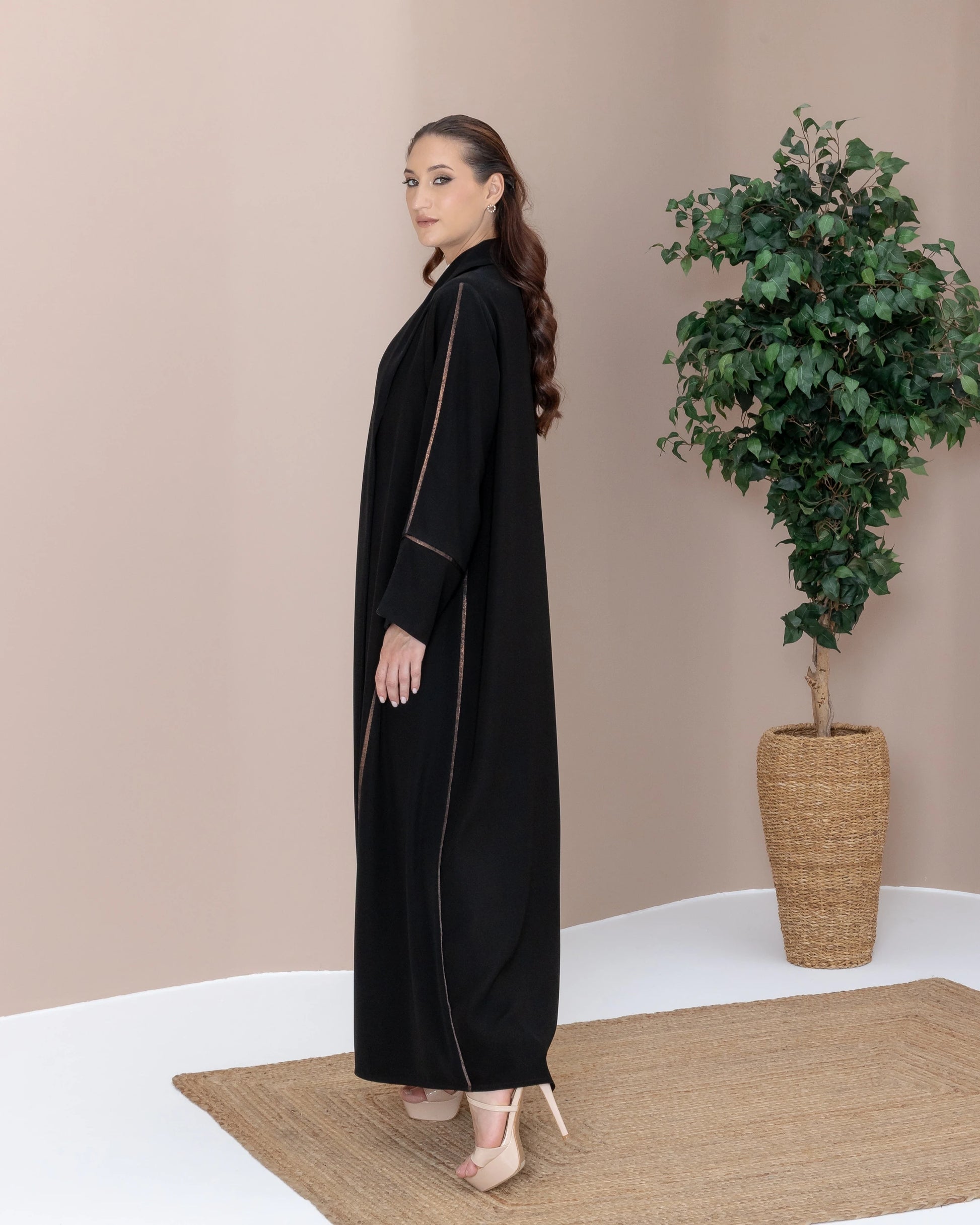 SAMRA Noir Bronze side-profile luxury abaya with bronze edge detailing