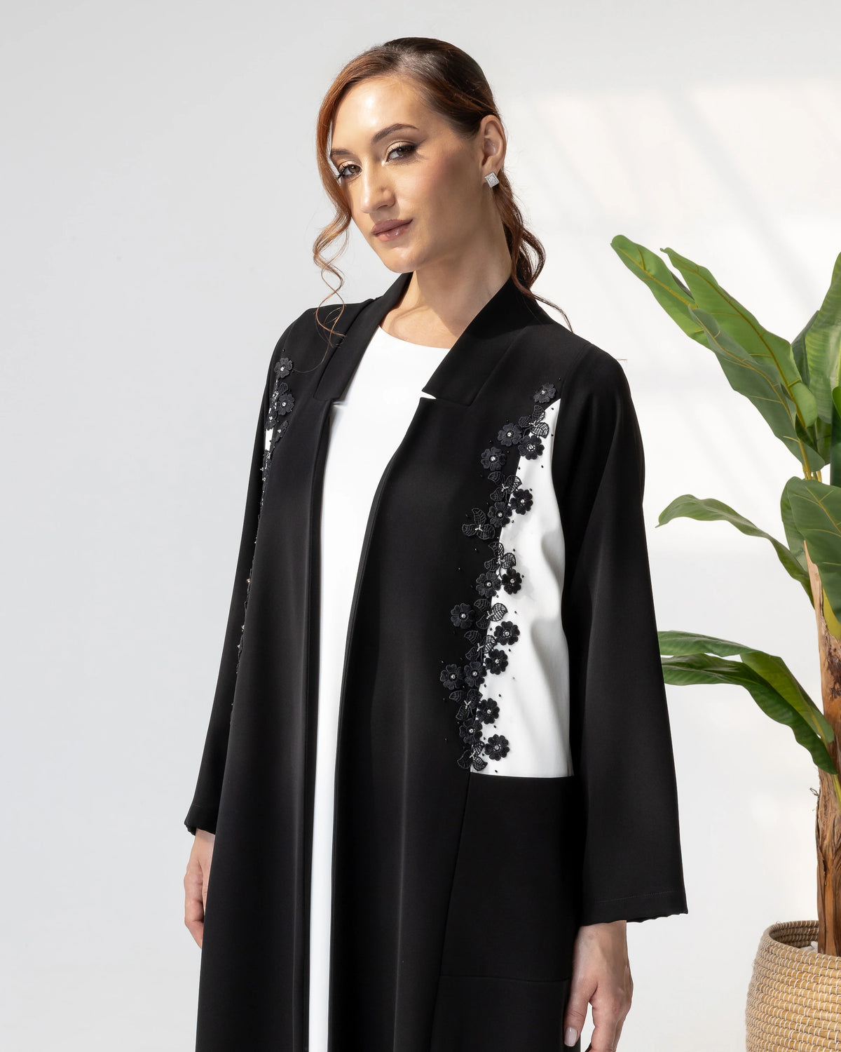 SARABAH Noir Mirage close-up of intricate floral embellishments on dual-tone abaya panels