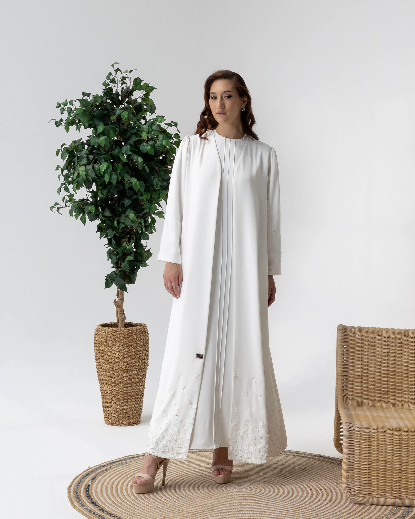 THALJIYYAH Snow-Blossom couture abaya featuring flowing silhouette and elegant pleated detailing