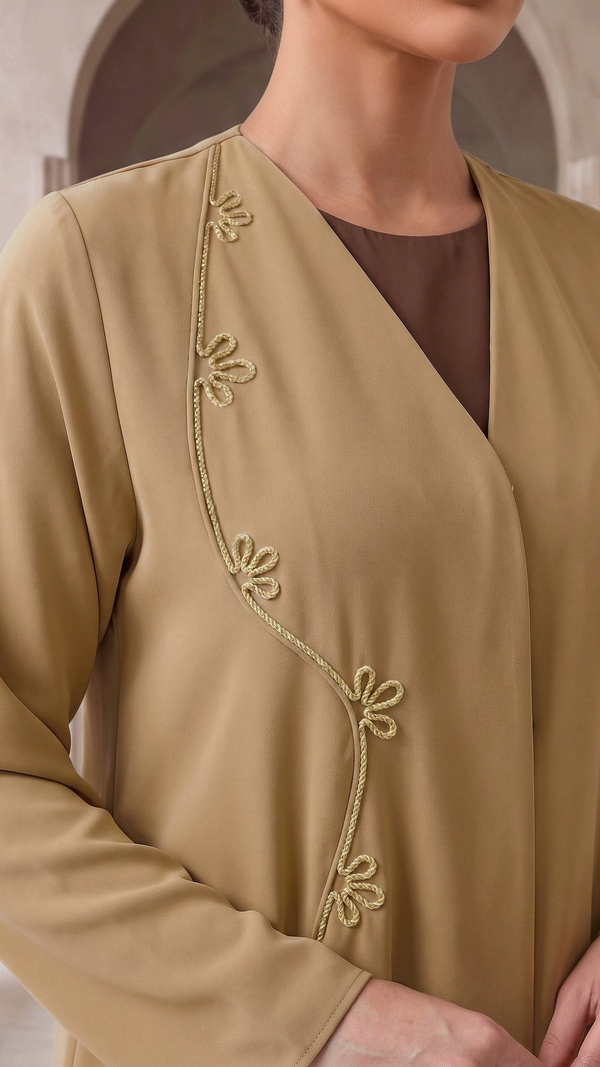 AFNAN gold vine embroidery at the chest