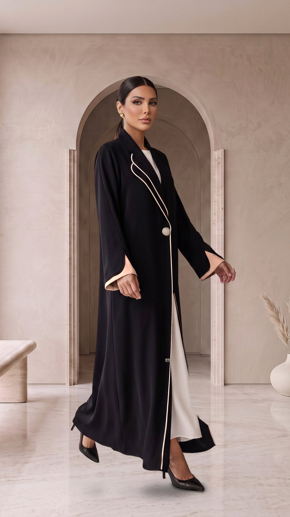 ALANOUD black abaya, three-quarter walking view with white inner