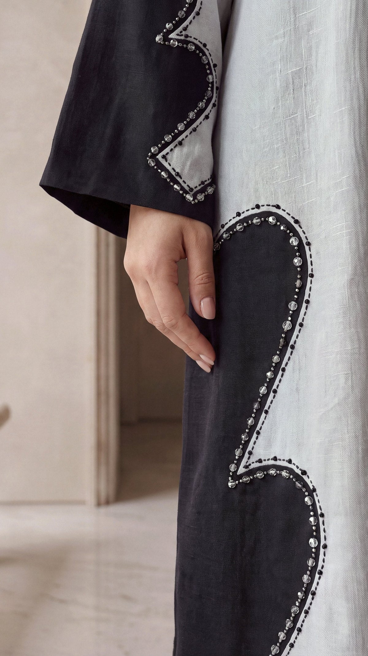LUJAIN beaded edge of black panel close-up