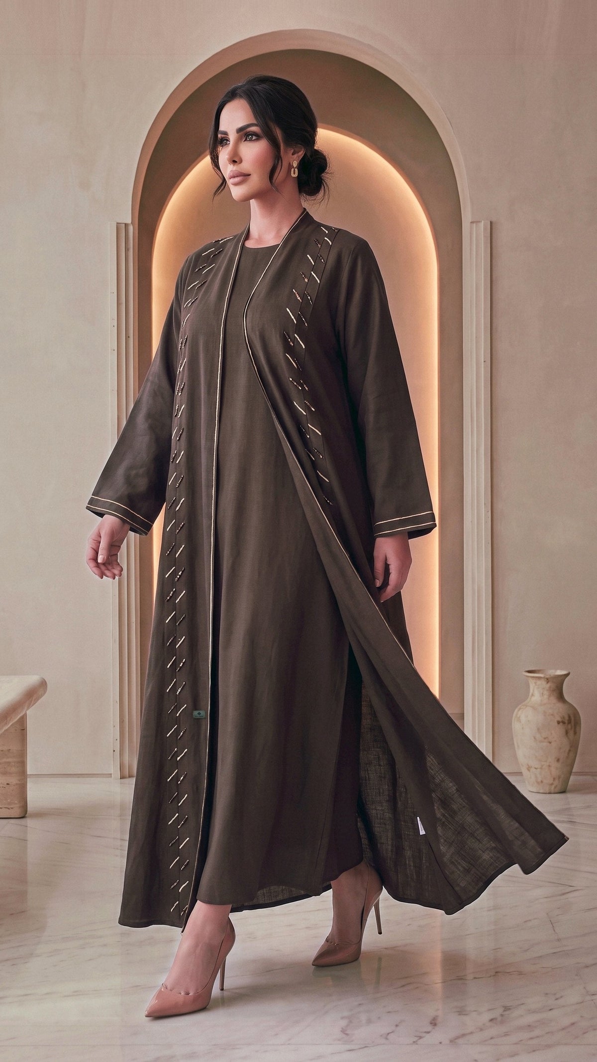 SIDRA espresso linen abaya, three-quarter walking view